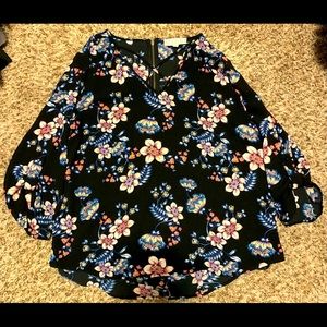 Women’s 3/4 sleeve. Crisscross front and zipper back. Black with floral pattern.